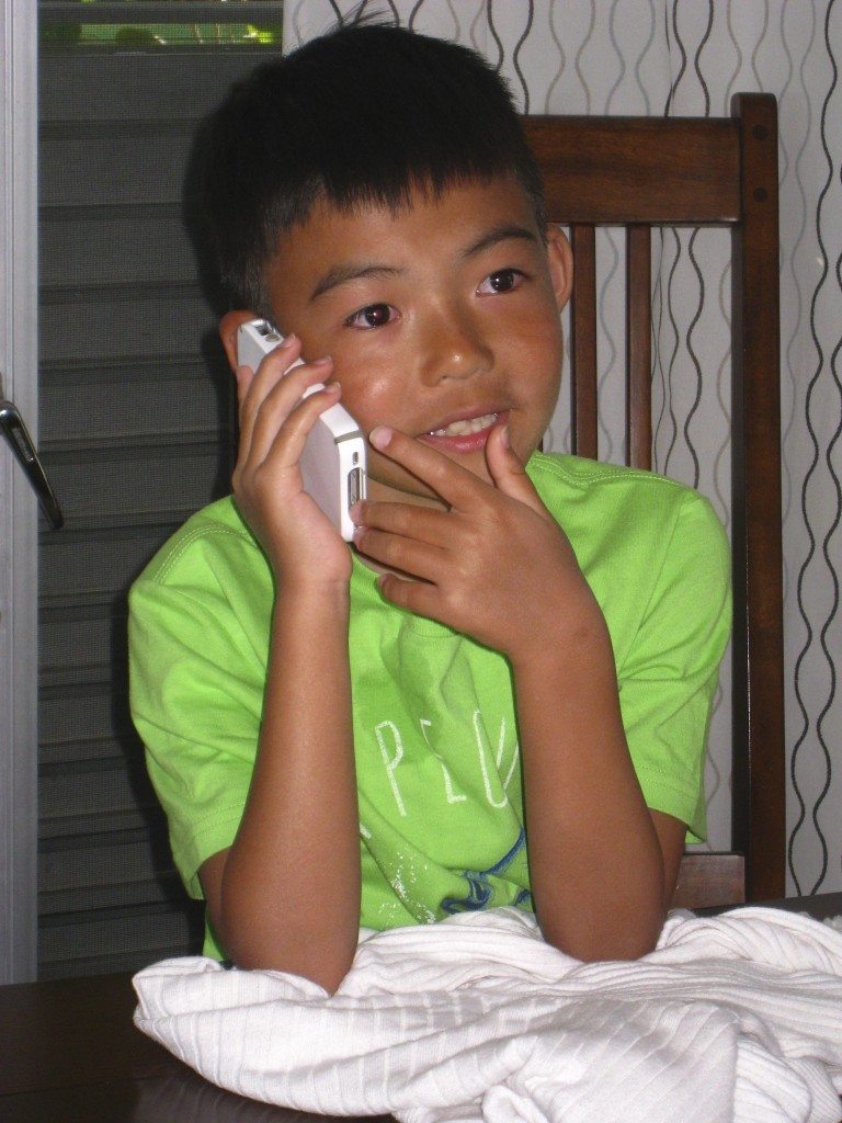  Ben talking to his foster sister on the phone.